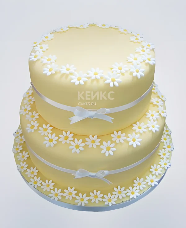 Желтый свадебный торт с ромашками и бантиком Фото