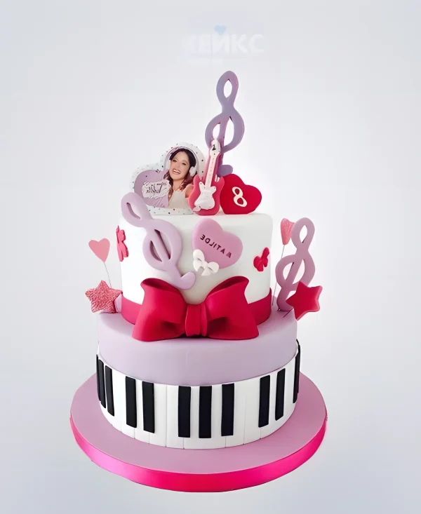 Розовый торт с клавишами и бантом для музыканта Фото