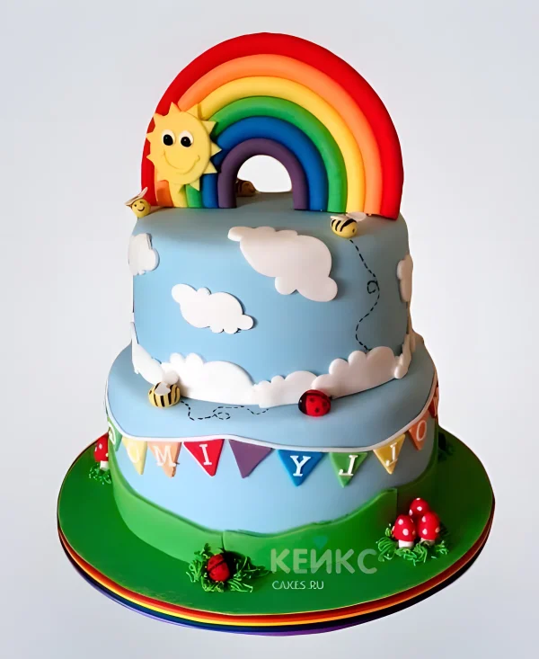 Двухъярусный торт с солнцем и радугой в облаках Фото