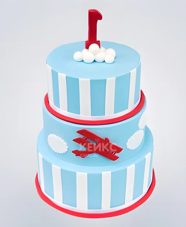 Голубой торт в полоску с красным самолетом Фото