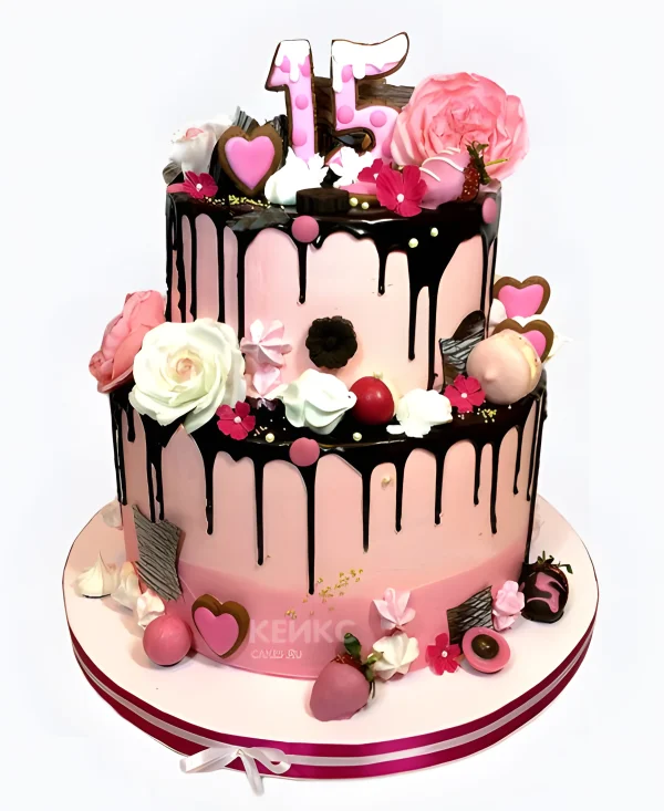 Двухъярусный торт со сладостями и цветами Фото