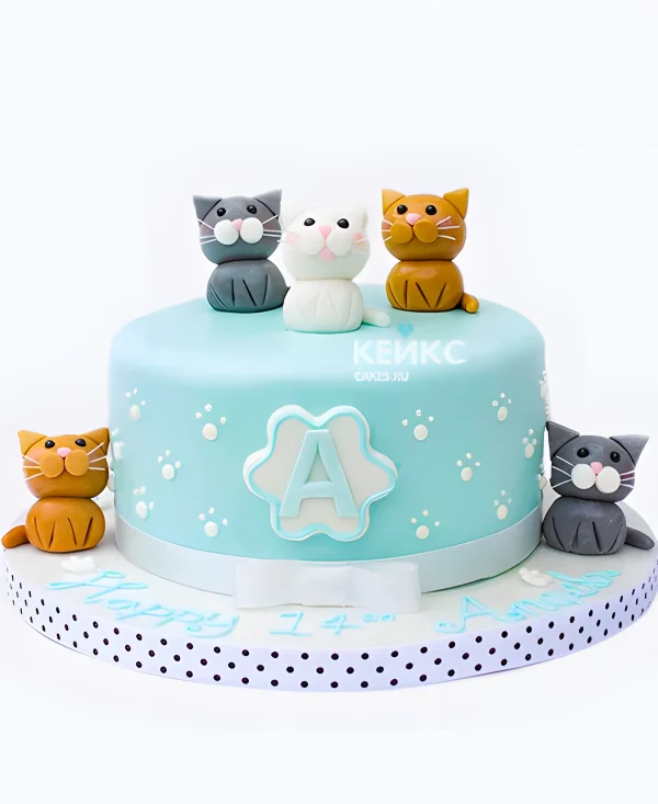 Голубой торт с лапками и фигурками кошек Фото
