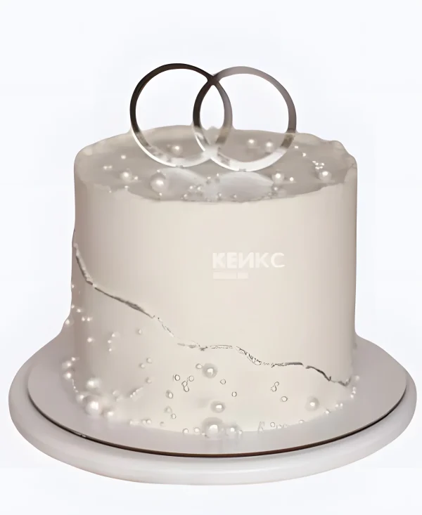 Свадебный торт с серебряными кольцами и жемчугом Фото