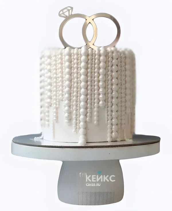 Свадебный торт с жемчугом и фигурками колец Фото