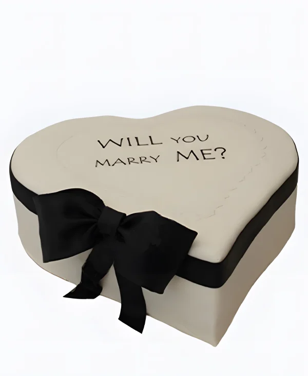 Торт в виде белого сердца с черным бантом на сватовство Фото